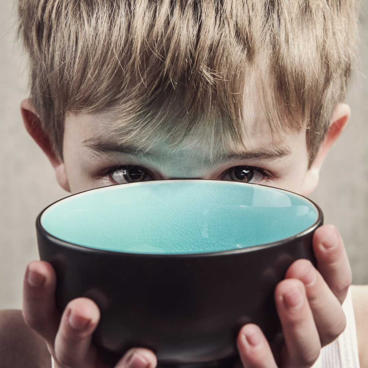 Boy looking over an empty bowl
