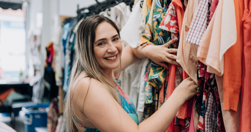 girl looking at clothes in a thrift store