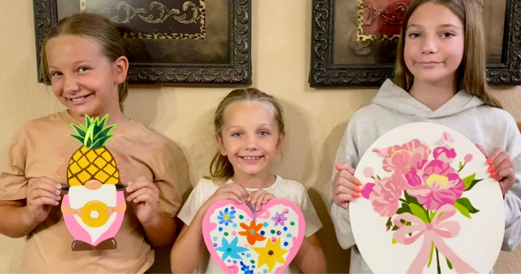children displaying their art creations. Frugal grandparenting activities.