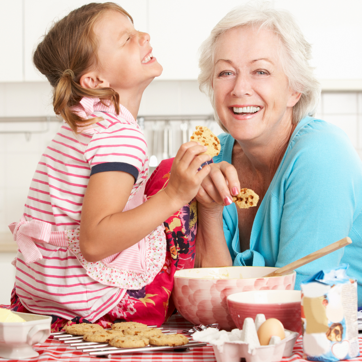 grandmother baking cookies with granddaughter